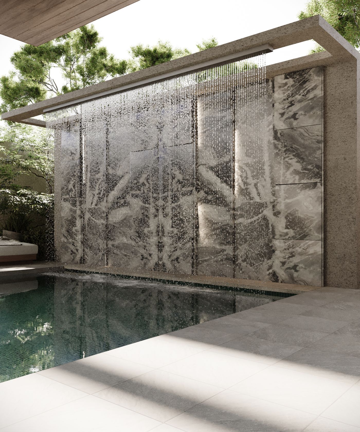 Sculptural stone water wall cascading into the pool — luxury landscape design Dammam